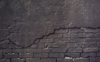 an old brick wall with a grungy surface