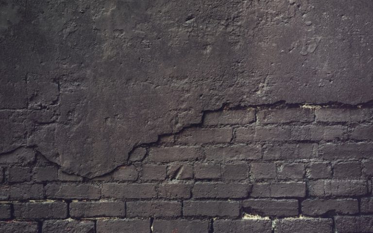 an old brick wall with a grungy surface