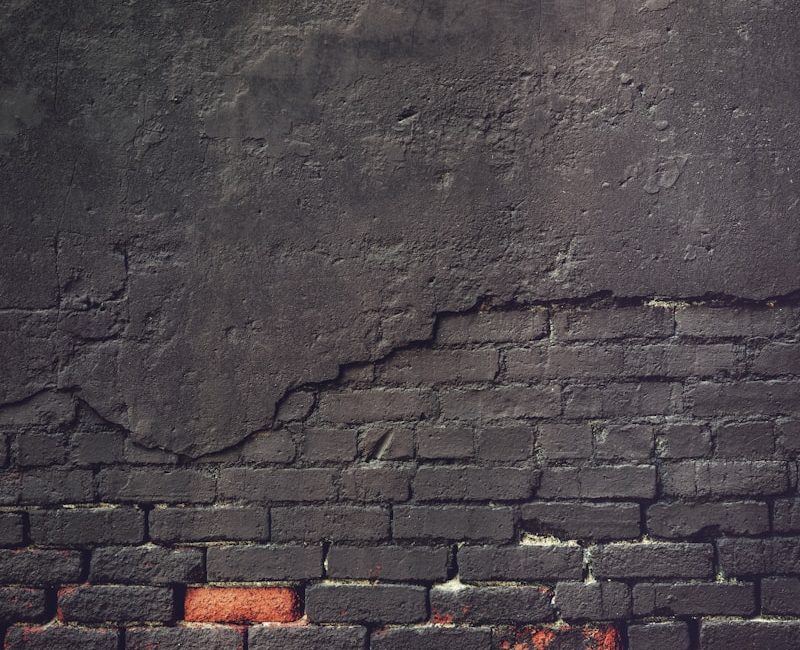an old brick wall with a grungy surface